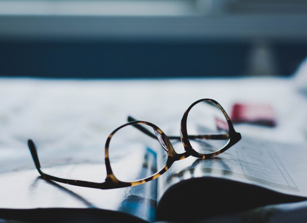 Glasses resting on open magazine