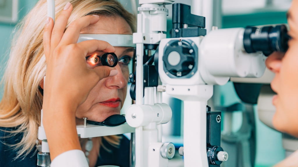 Ophthalmologist examining a patient's eye with a slit lamp.