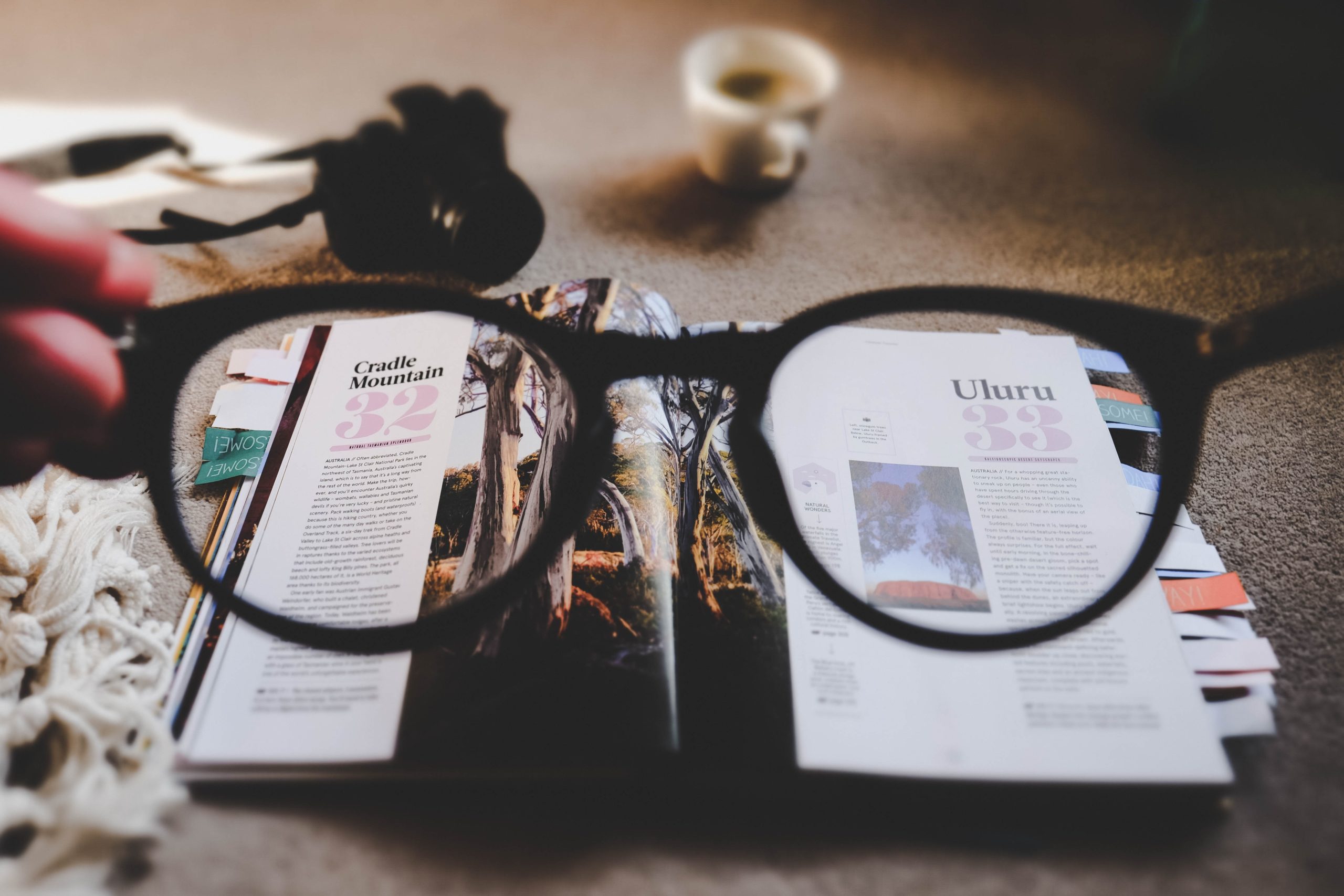 looking through glasses at a magazine